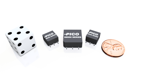A die, three black electronic components labeled "Pico 68000 Series," and a 2019 U.S. penny are arranged in a line on a white surface.