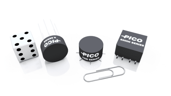 A row of electronics components labeled "Pico," including three different types and a paperclip, next to a die showing five dots.