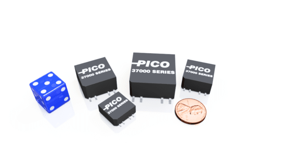 Four black PICO 37000 Series electronic components, a blue six-sided die, and a U.S. penny are placed on a white surface.