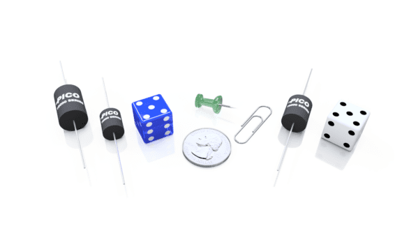 Four capacitors, two blue dice, a green pushpin, a paperclip, a quarter, and a black-and-white die arranged on a white background.