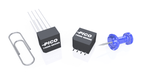 A paperclip, two black electronic components labeled "PICO 74000 SERIES" and "PICO 78000 SERIES," and a blue pushpin are arranged on a white surface.
