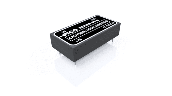 A black electronic component, labeled "Pico Series Out - Caution: High Voltage," with metal pins protruding from the bottom, is placed on a white reflective surface.