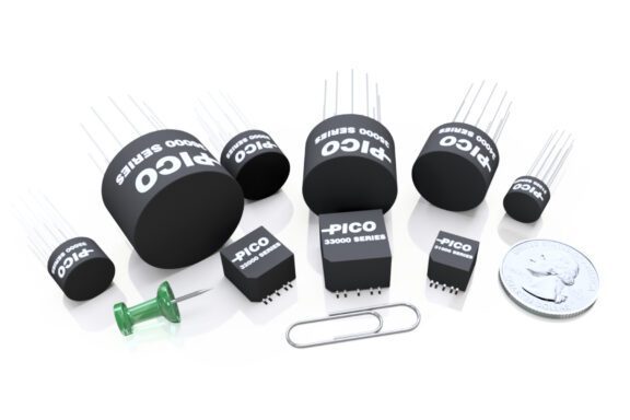 Several DC-DC converters next to a thumb tack, paperclip, and USD quarter to illustrate the size of the components.