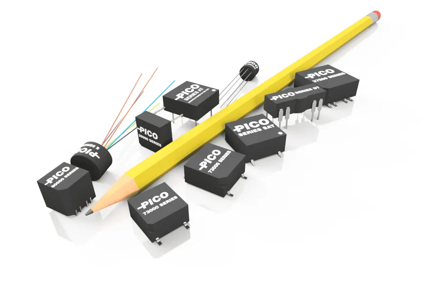 A group of electronic components, including relays and a transistor, arranged next to a yellow pencil for size comparison.